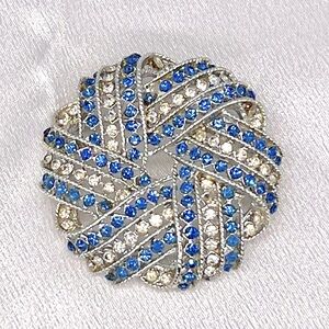 203-B. Vintage Rhinestone Pinwheel Brooch. 1 3/4” Diameter. Circa: 1950s.